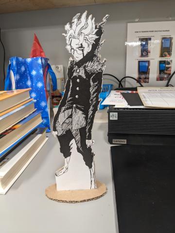 A cardboard standee of Okarun from Dandadan
