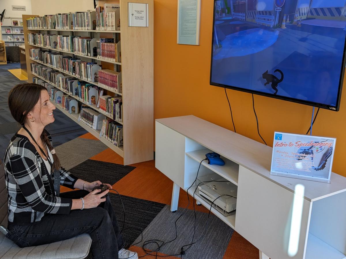 girl playing a videogame on a x box