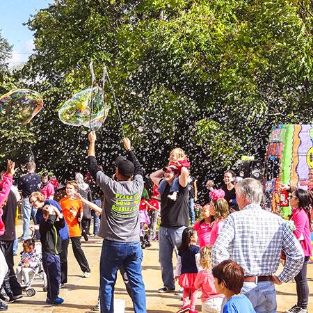 children playing surrounded by bubbles 